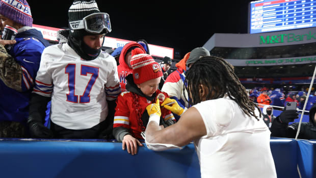 Andy Radzavicz of Jacksonville, Florida, gets an autograph from Chiefs Isiah Pacheco who also gave him his gloves. Radzavicz drove up with his father to see the game.